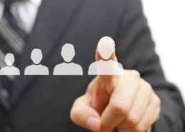 The Rise of the Flexible Staffing Model - business person with finger on graphic of people icon.