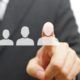 The Rise of the Flexible Staffing Model - business person with finger on graphic of people icon.